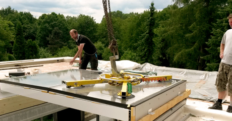 Workers of M-Tec Glaserei Ltd. is working on glass roof